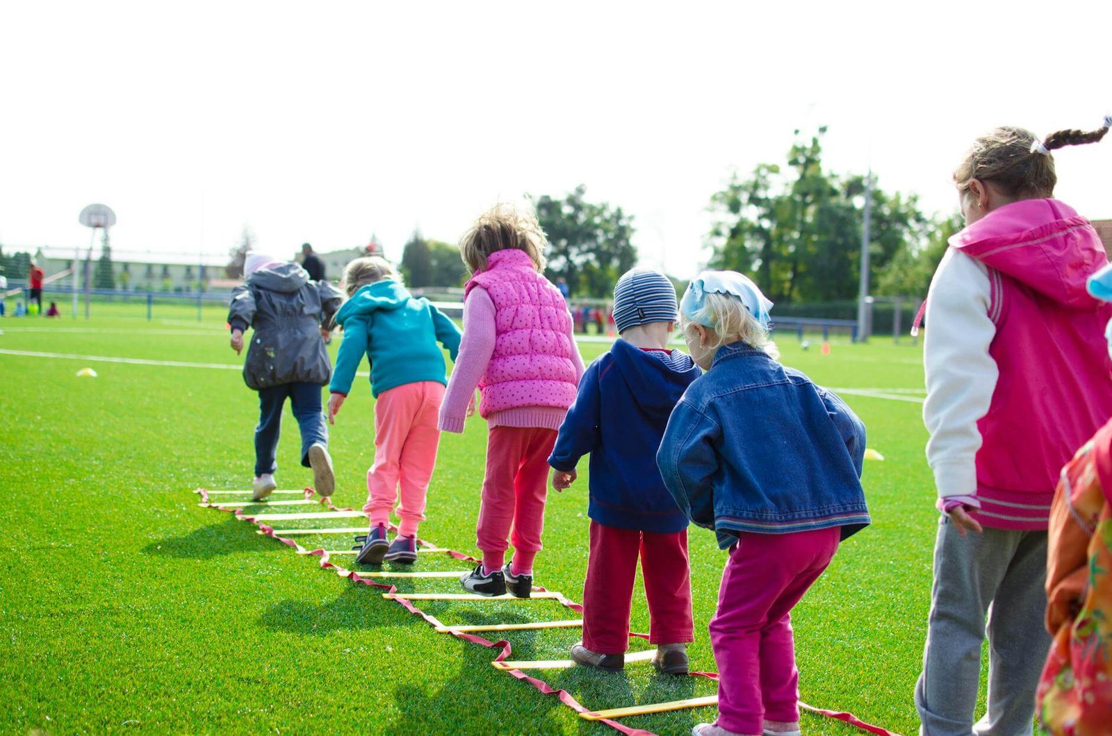 children's team engaged in collaborative and joyful learning and building on green grassland. With CurioBuddy learning is a joyful journey for kids, not a chore.