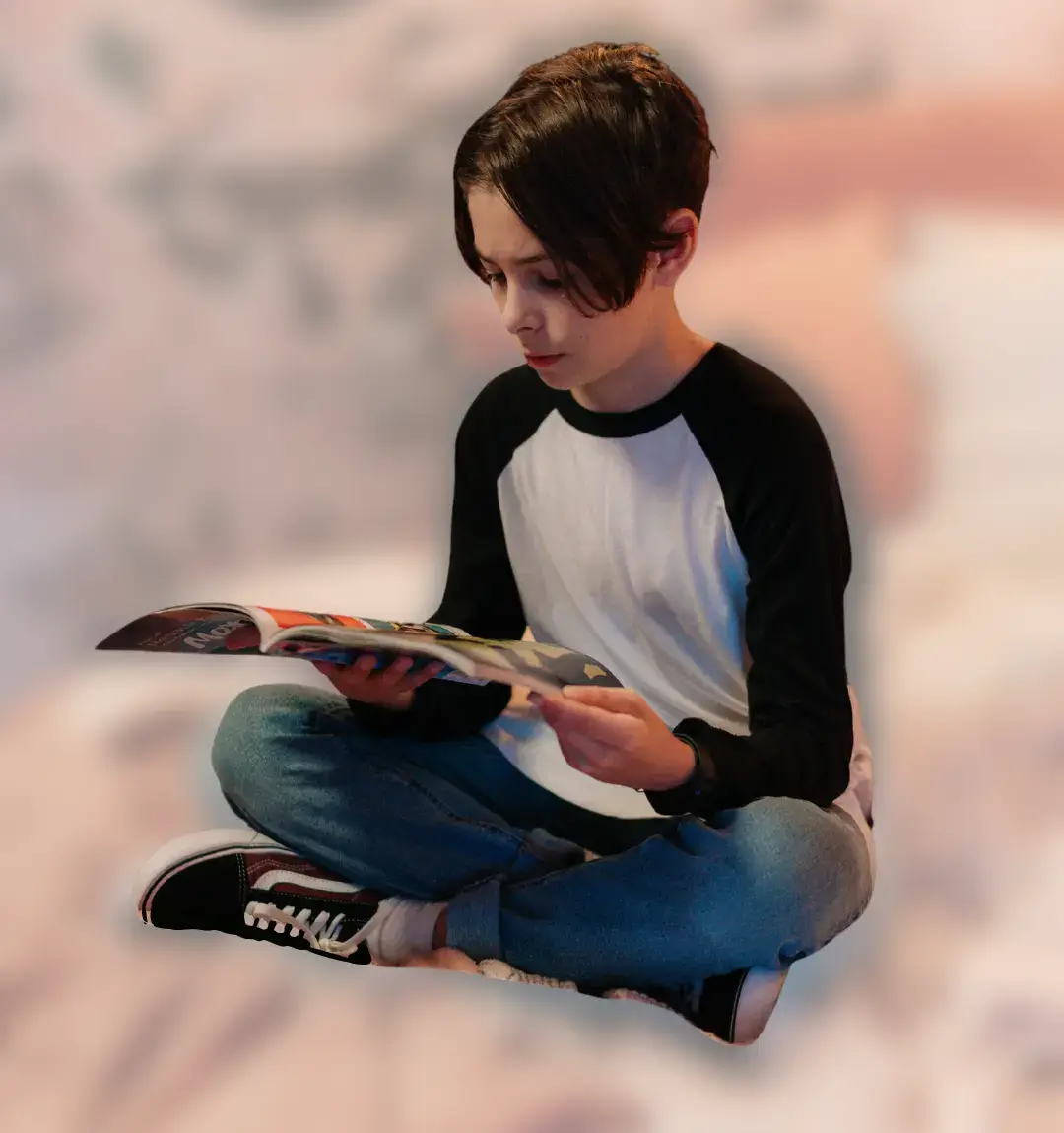Child engrossed in reading CurioBuddy magazine at home